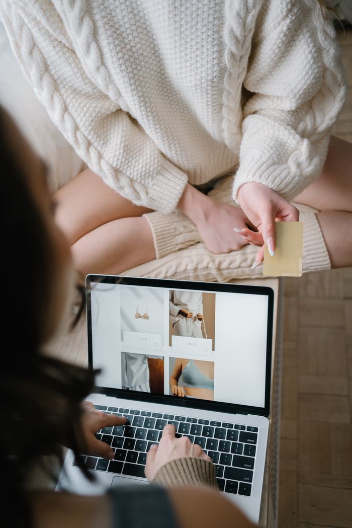 who-we-are Two people using a laptop for online shopping, highlighting modern e-commerce trends.